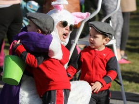 Brothers Jameson and Liam Berry give the Easter Bunny a big hug at the 20th annual Calvin Park Easter Egg Hunt in Kingston, Ont. on Saturday April 15, 2017. Steph Crosier/Kingston Whig-Standard/Postmedia Network