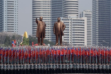 University students carry the national flag and two bronze statues of the late leaders Kim Il Sung and Kim Jong Il during a military parade on Saturday, April 15, 2017, in Pyongyang, North Korea, to celebrate the 105th birth anniversary of Kim Il Sung, the country's late founder and grandfather of current ruler Kim Jong Un. (AP Photo/Wong Maye-E)