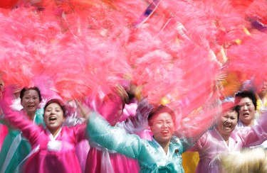 North Korean women wave and cheer as they look toward their leader Kim Jong Un during a military parade Saturday, April 15, 2017, in Pyongyang, North Korea, to celebrate the 105th birth anniversary of Kim Il Sung, the country's late founder and grandfather of current ruler Kim Jong Un. (AP Photo/Wong Maye-E)