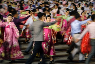 North Korean men and women participate in a mass dance on Saturday, April 15, 2017, in Pyongyang, North Korea to celebrate the 105th birth anniversary of Kim Il Sung, the country's late founder and grandfather of current ruler Kim Jong Un. (AP Photo/Wong Maye-E)