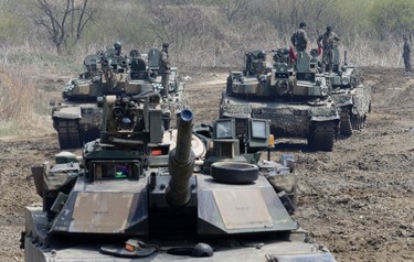 South Korean army soldiers stand on their tanks during a joint military exercise between the U.S. and South Korea in Paju, near the border with North Korea, South Korea, Saturday, April 15, 2017. U.S. President Donald Trump's tweets are adding fuel to a "vicious cycle" of tensions on the Korean Peninsula, North Korea's vice foreign minister told The Associated Press in an exclusive interview Friday. The official added that if the U.S. shows any sign of "reckless" military aggression, Pyongyang is ready to launch a pre-emptive strike of its own. (AP Photo/Ahn Young-joon)