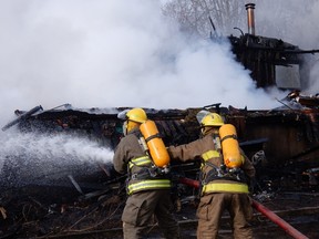 Submitted Photo
Quinte West firefighters battle a house fire on Loyalist Parkway early Saturday morning.