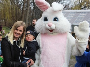 Laura and Laker Moore pose with the Easter Bunny at Canatara Park Saturday during Easter in the Park. Thousands turned out for the annual event despite rain. Tyler Kula/Sarnia Observer/Postmedia Network