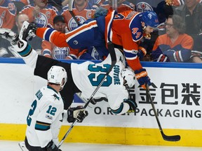 Edmonton's Zack Kassian (44) hits San Jose's Logan Couture (39) while Patrick Marleau (12) watches during the second period of a Stanley Cup playoffs game between the Edmonton Oilers and the San Jose Sharks at Rogers Place in Edmonton on Friday, April 14, 2017.