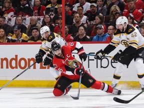Erik Karlsson of the Ottawa Senators controls the puck as he holds off Brad Marchand and David Backes of the Boston Bruins in the first period in Game 2 at Canadian Tire Centre on April 15, 2017. (Jana Chytilova/Freestyle Photography/Getty Images)