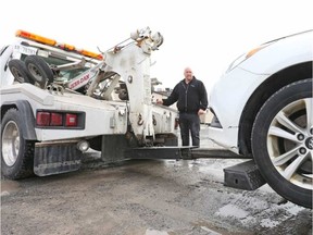 Park Safe manager Marc Proulx demonstrates one of his company's tow trucks that can hook and tow an illegally parked vehicle in under a minute.