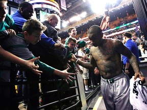 Boston Celtics guard Isaiah Thomas is congratulated by fans after defeating the Milwaukee Bucks in an NBA game in Boston on April 12, 2017. (AP Photo/Charles Krupa)