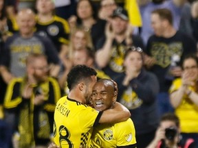 Columbus Crew midfielder Niko Hansen (left) and forward Ola Kamara celebrate a Crew goal against Toronto FC during last night’s game at Mapfre Stadium. (AP)