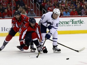 Maple Leafs defenceman Jake Gardiner (right) battles with the Capitals’  Matt Niskanen during the first period of Game 2 of their series in Washington last night. Gardiner was a horse on the blue line for the Leafs in their double overtime win. (Getty Images)