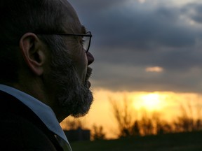 Belleville-resident Steve Fritz watches the rising run from a hill at Zwick’s Park on Sunday April 16, 2017 in Belleville, Ont. Fritz had shown up early for the annual Salvation Army Easter Sunrise Service before learning this year's ceremony had been moved to the Salvation Army Belleville Citadel building on Bridge Street West due to weather concerns. Tim Miller/Belleville Intelligencer/Postmedia Network