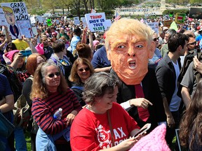Protesters gather on Capitol Hill in Washington, Saturday, April 15, 2017, during a Tax Day demonstration calling on President Donald Trump to release his tax returns. (AP Photo/Manuel Balce Ceneta)