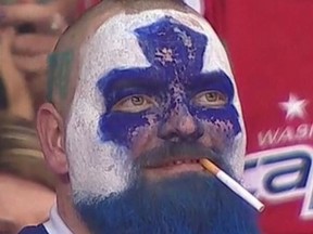 A cigarette dangles from the mouth of hard-core Maple Leafs fan Jason Maslakow during Game 2 in Washington. (TWITTER)