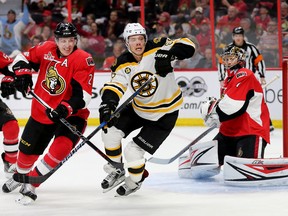 Senators defenceman Dion Phaneuf (left) tries to hold up David Pastrnak of the Bruins with goalie Craig Anderson looking on during Game 1 of their playoff series in Ottawa on Wednesday, April 12, 2017. (Wayne Cuddington/Postmedia)