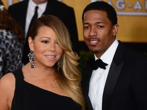 Singer Mariah Carey and husband Nick Cannon attend the 20th annual Screen Actors Guild (SAG) Awards on January 18, 2014 at the Shrine Auditorium in Los Angeles. AFP PHOTO / FREDERIC J. BROWN (Photo credit should read FREDERIC J. BROWN/AFP/Getty Images)