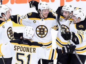 Bruins centre Patrice Bergeron (37) celebrates his goal with Ryan Spooner (51), Charlie McAvoy (73), David Pastrnak (88) and Brad Marchand (63) against the Senators during Game 2 of their first-round playoff series in Ottawa on Saturday, April 15, 2017. (Sean Kilpatrick/The Canadian Press)