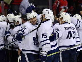 Brian Boyle (left) and Matt Martin celebrate as fellow fourth-liner Kasperi Kapanen is mobbed by teammates after scoring the winning goal against the Capitals in double-OT on Saturday. (GETTY IMAGES)