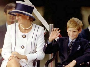 Princess Diana, left, and her son Harry watch veterans as they march past a dais on the Mall as part of the commemorations of VJ Day, August 19, 1995. The commemoration was held outside Buckingham Palace and was attended by 15,000 veterans and tens-of-thousands of spectators. (ALLAN LEWIS/AFP/Getty Images)