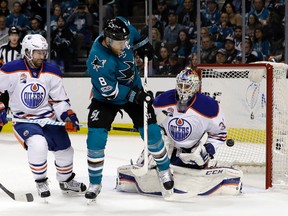 Edmonton Oilers goalie Cam Talbot stops a shot from San Jose Sharks center Joe Pavelski next to Oilers center David Desharnais on Sunday, April 16, 2017, in San Jose, Calif. (Marcio Jose Sanchez/AP Photo)