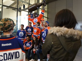 Fans get their photo with Wayne Gretzky's statue before the Edmonton Oilers play the San Jose Sharks during the Oilers Orange Crush Road Game Watch Party at Rogers Place in Edmonton on Sunday, April 16, 2017. Ian Kucerak / Postmedia