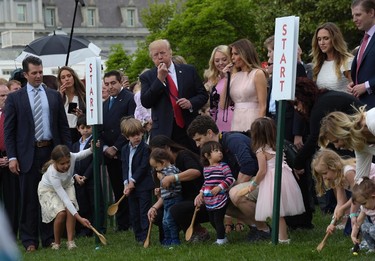 President Donald Trump, center, and first lady Melania Trump, third from right, along with members of the first family, watch as President Trumps blows the whistle to begin an Easter Egg Roll race on the South Lawn of the White House in Washington, Monday, April 17, 2017, during the annual White House Easter Egg Roll. (AP Photo/Susan Walsh)