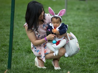 Eleven-month-old Victoria Cheng and her mother Guliana Cheng, both from San Francisco, prepare to participate in the White House Easter Egg Roll on the South Lawn of the White House in Washington, Monday, April,17, 2017. President Donald Trump and first lady Melania Trump are set to host the official annual Easter egg roll at the White House. (AP Photo/Carolyn Kaster)