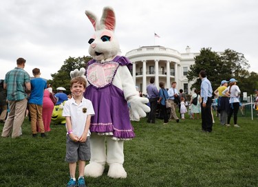 Michael McGee, 5, poses with an Easter bunny during the White House Easter Egg Roll on the South Lawn of the White House in Washington, Monday, April, 17, 2017. President Donald Trump and first lady Melania Trump are set to host the official annual Easter egg roll at the White House. (AP Photo/Carolyn Kaster)