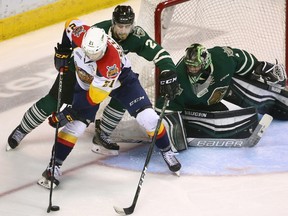 Evan Bouchard of the Knights tries to control Patrick Fellows of the Otters as he tries a wrap around on Tyler Parson in the third period of their game 6 at Budweiser Gardens on Sunday April 16, 2017. (Mike Hensen/The London Free Press/Postmedia Network)