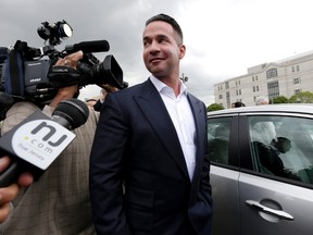 In this Sept. 24, 2014, file photo, reporters gather around Michael "The Situation" Sorrentino as he leaves the MLK Jr. Federal Courthouse in Newark, N.J., after a court appearance. Michael Sorrentino and his brother Marc Sorrentino are set to appear in court to face additional tax fraud charges are scheduled to be arraigned on Monday, April 17, 2017, in federal court in Newark. They previously pleaded not guilty to charges they filed bogus tax returns on nearly $9 million and claimed millions in personal expenses as business expenses. (AP Photo/Julio Cortez, File)
