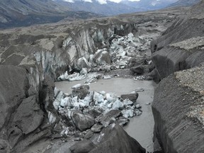 In this photo provided by Jim Best at the University of Illinois, taken in 2016, a close-up view of the ice-walled canyon at the terminus of the Kaskawulsh Glacier, with recently collapsed ice blocks. This canyon now carries almost all meltwater from the toe of the glacier down the Kaskawulsh Valley and toward the Gulf of Alaska and the Pacific Ocean instead of the Bering Sea. (Jim Best/University of Illinois via AP)