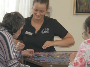 Oaks Retirement Village employee Courtney Shephard, works on a puzzle with a pair of residents recently. Oaks Retirement Village recently opened up an expansion, increasing their number of suites, including adding 25 memory care suites for individuals who are living with and managing Alzheimer's and dementia.