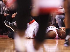 Toronto Raptors forward Serge Ibaka grimaces in pain after falling against the Milwaukee Bucks during second half NBA playoff basketball action in Toronto on April 15, 2017. (THE CANADIAN PRESS/Frank Gunn)