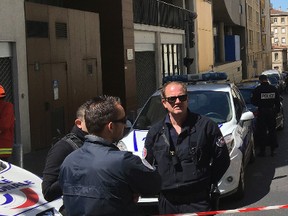 A police officer and rescue workers cordon off a street during searches in Marseille, southern France, Tuesday, April 18, 2017. French police thwarted an imminent "terror attack," arresting two suspected radicals Tuesday in the southern port city of Marseille, the interior minister said just days before the first round of France's presidential election. (AP Photo/Claude Paris)