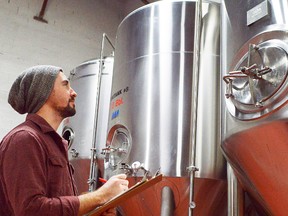 Colin Chrysler takes stock of a fermenting tank in the new Sons of Kent brewery near downtown Chatham. He says the business hopes to open in early June and should have products available in Chatham-Kent as early as the next few weeks.