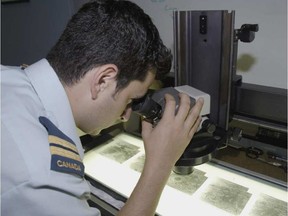 DND photo
This August 2007 file photo shows Captain Mark Chlistovski, an Aeronautical Engineer employed as a Sensor Officer with Open Skies Canada. He is shown here examining aerial film that was shot over the territory of the Russian Federation.
