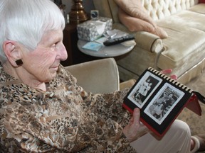 Marie Strapp, 90, of Grand Bend, looks at a photo she took of Geraldine Robertson at the former Mount Elgin Indian Industrial School in Muncey, Ont. Strapp, who worked at the residential school, recently reconnected with Robertson who is now an Aamjiwnaang First Nation elder who shares her story as a residential school survivor. Lynda Hillman-Rapley/Postmedia Network