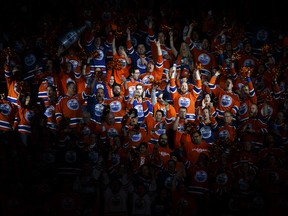 Oilers fans sing the national anthem before the first period of a Stanley Cup playoffs game between the Edmonton Oilers and the San Jose Sharks at Rogers Place in Edmonton on Friday, April 14, 2017.