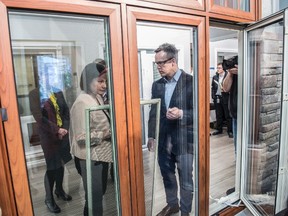 Environment Minister Shannon Phillips looks at a triple pane glass window at All Weather Windows in Edmonton, AB on April 18,  2017. The minister announced Energy Efficiency Alberta’s new program that will provide rebates to Albertans for renovations on windows, tankless hot water heaters and insulation. Photo by Shaughn Butts / Postmedia