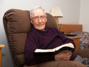 Albert Tovell holds a bible in his room at the Vermilion Valley Lodge  on Wednesday, April 12, 2017, in Vermilion, Alta.  Taylor Hermiston/Vermilion Standard/Postmedia Network.