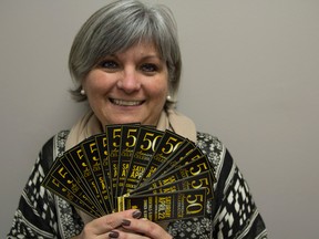 Bea Serdon/The Intelligencer
Brenda Snider, Executive Director of Volunter & Information Quinte, holds up tickets for their upcoming 50th Anniversary Volunteer Celebration Night. The night will honour volunteers and organizations that have helped the VIQ.