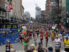Runners head to the finish line in the 121st Boston Marathon in Boston on Monday, April 17, 2017 (AP Photo/Elise Amendola)