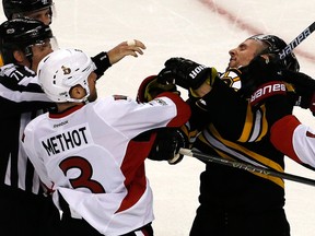 Senators’ Marc Methot punches the Bruins’ Tim Schaller during Game 3 in Boston. Methot had five hits during the game. (Getty Images)