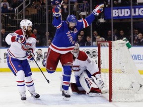 New York Rangers left wing Rick Nash (61) celebrates after scoring a goal as Montreal Canadiens' Jordie Benn, left, and goalie Carey Price, right, watch during the second period of an NHL hockey game in Game 4 of an NHL hockey first-round playoff series Tuesday, April 18, 2017, in New York. (AP Photo/Frank Franklin II)