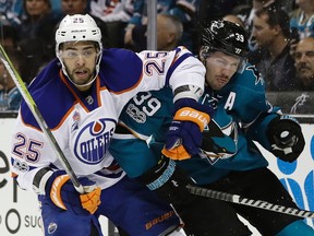 San Jose Sharks' Logan Couture (39) gets tangled with Edmonton Oilers' Darnell Nurse (25) during the first period in Game 4 of a first-round NHL hockey playoff series Tuesday, April 18, 2017, in San Jose, Calif.