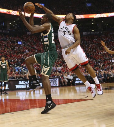 Toronto Raptors Kyle Lowry G (7) reaches over top of Milwaukee Bucks Khris Middleton G (22) during the second half of Game 2 in Toronto, Ont. on Wednesday April 19, 2017. Jack Boland/Toronto Sun/Postmedia Network