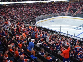 Fans watch the Oilers in San Jose taking on the Sharks, during game 4 on the score board screen at Rogers Place during the Oilers Orange Crush Road Game Watch Party in Edmonton, April 18, 2017.
