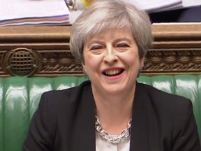 A still image taken from footage broadcast by the UK Parliamentary Recording Unit (PRU) on April 19, 2017 shows British Prime Minister Theresa May laughing during Prime Ministers questions in the House of Commons in London. Britain's parliament votes today on holding a snap election in June, as Prime Minister Theresa May seeks to make strong gains against the opposition before gruelling Brexit negotiations. / (PRU AND AFP PHOTO/ Handout)