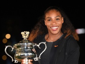 Serena Williams poses with the championship trophy after her victory against Venus Williams in the women's singles final on Day 13 of the Australian Open tennis tournament in Melbourne on January 29, 2017.  (SAEED KHAN/AFP/Getty Images)