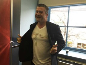 Coun. Tim Tierney shows off a T-shirt he had made of the map showing where LRT and Trillium lines will go after Stage 1 and Stage 2 of construction.