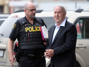 Convicted sex offender Neil Joynt is escorted out of court after being sentenced to eight months in prison during a sentencing hearing in Napanee on Wednesday. (Steph Crosier/The Whig-Standard)