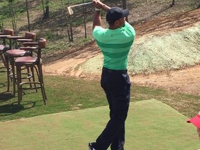 Tiger Woods takes a tee shot at the 19th hole of the new Payne's Valley in Ridgedale, Mo. (Ken Wiebe/Winnipeg Sun)